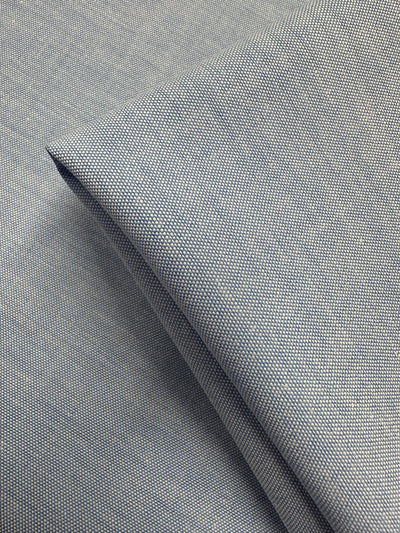 A close-up of two overlapping pieces of Super Cheap Fabrics' Oxford Cotton in Little Boy Blue (146cm), highlighting the finely woven cotton texture and smooth surface.