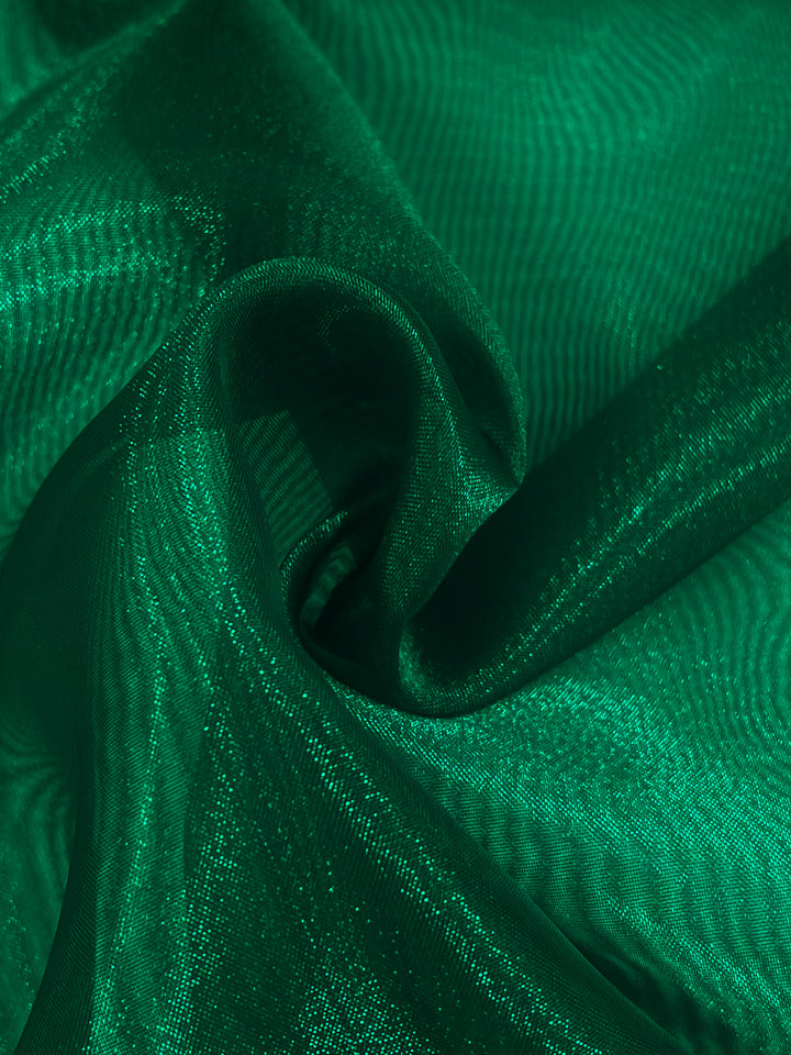 Close-up of vibrant green Organza - Lush Meadow - 150cm by Super Cheap Fabrics; lightweight and swirling with shiny, translucent elegance, soft folds, and highlights.