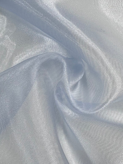 Close-up of Super Cheap Fabrics' Organza in blue (150cm), showing lightweight, semi-sheer material with soft folds and gentle waves for a smooth, slightly translucent texture.