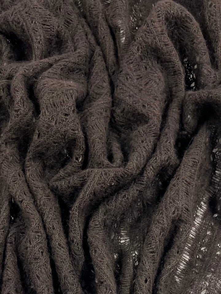 Close-up of Wool Knit - Dark Chocolate - 140cm by Super Cheap Fabrics, showing its loosely knit, textured, and fuzzy wool surface with gathered, wavy folds.