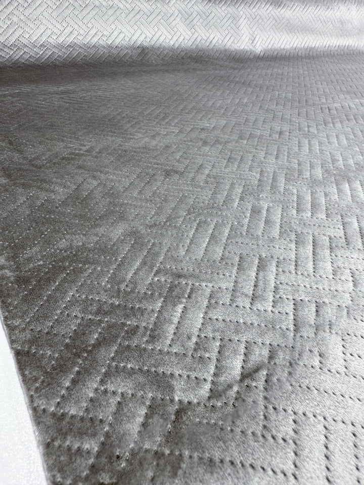 Close-up of Embossed Velvet - Silver (150cm) by Super Cheap Fabrics, featuring a textured chevron and dotted geometric pattern—ideal for modern upholstery or stylish home décor accents.