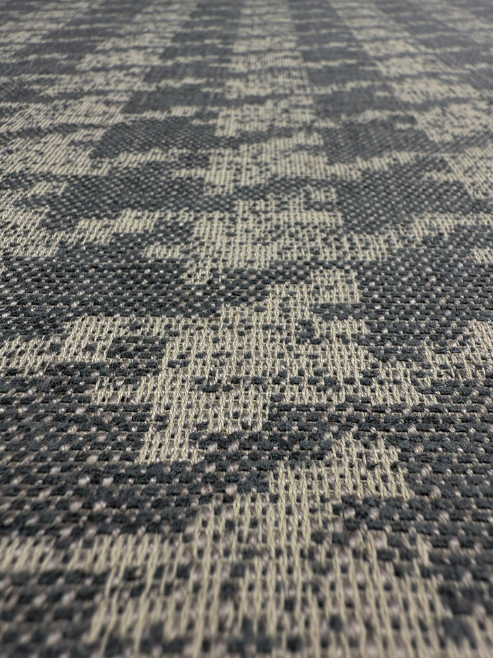 Close-up of Super Cheap Fabrics' Upholstery Jacquard - Westwood Grey Dusk (154cm), featuring textured woven fibers and a geometric pattern in gray and beige—perfect for high-end upholstery.