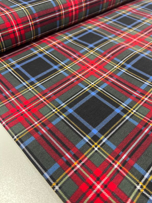 A close-up of Super Cheap Fabrics' Printed Bengaline - Uniform (150cm) medium-weight fabric showcases a classic tartan pattern in red, green, and blue with yellow and white accents. The plaid design features intersecting lines and squares on stretch bengaline for a vibrant look.