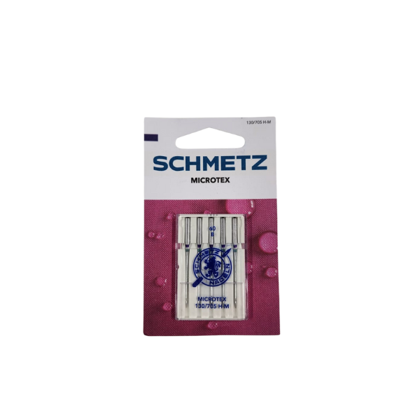 A package of Super Cheap Fabrics Machine Needles Microtex is shown against a white background, featuring purple and pink designs on the lower part of the packaging.
